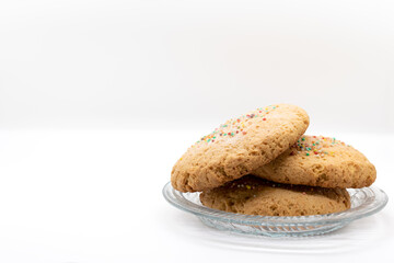 Fresh Cookies stacked on a transparent glass plate selective focus, copy space