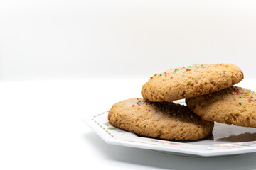 Stack of fresh cookies on plate, selective focus, copy space, product