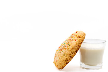 Cookie lying on glass of milk isolated on white background, selective focus, copy space