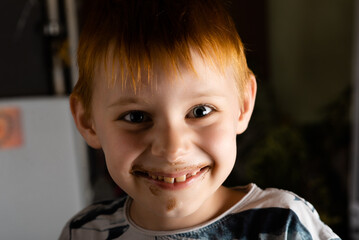 A young boy with a soiled ice cream face.