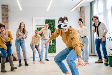 One man in front of group of friends enjoy virtual reality VR headset