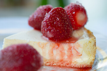 cheesecake topped with strawberries and strawberry syrup