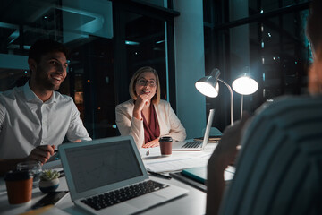 They know the true meaning of dedication. colleagues having a meeting during a late night in a...