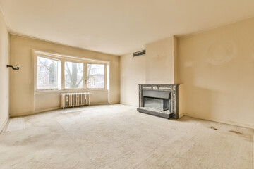 an empty living room with a fire place in the corner and no one on the floor or furniture to be seen