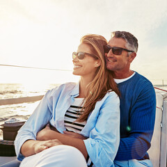 Look at that beautiful view. a couple enjoying a boat cruise out on the ocean.