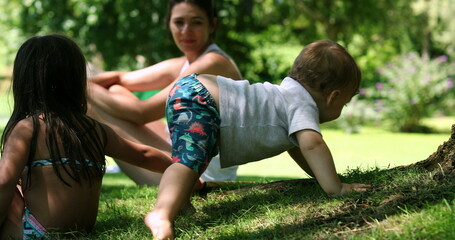 Cute baby discovering lawn. Adorable toddler infant exploring garden outdoors