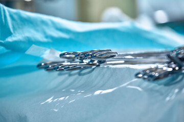Close-up of surgical instruments on the table in the operating room, modern medicine, sterilization of medical instruments