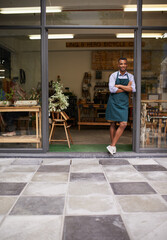 Welcome portrait, coffee shop and man as small business owner at front door with a smile....