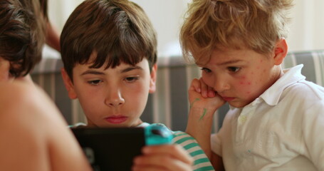 Children at home playing game on tablet