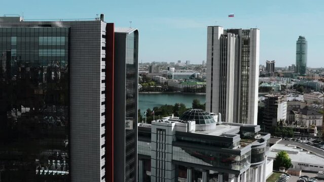 A bird's-eye view of the daytime landscape. Stock footage. Tall new glass offices around the lake and roads with cars shot in the heart of a big city.