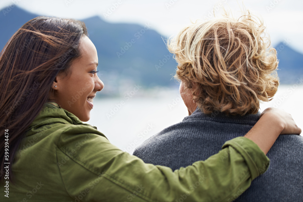 Wall mural sharing a spectacular view together. an attractive young couple enjoying a day outdoors together.