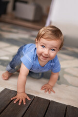 Naklejka premium The cutest smile. an adorable little infant crawling on the floor.
