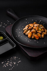 Delicious marinated mussels with spices and herbs on a ceramic plate