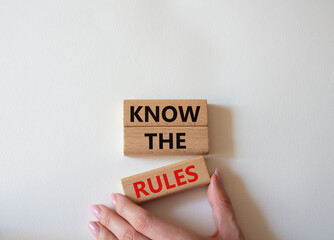 Know the rules symbol. Wooden blocks with words Know the rules. Beautiful white background. Businessman hand. Business and Know the rules concept. Copy space.