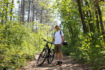 Man in forest with bicycle