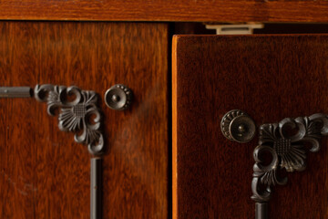 Old soviet lacquered brown wardrobe as a background, the doors of an old nightstand