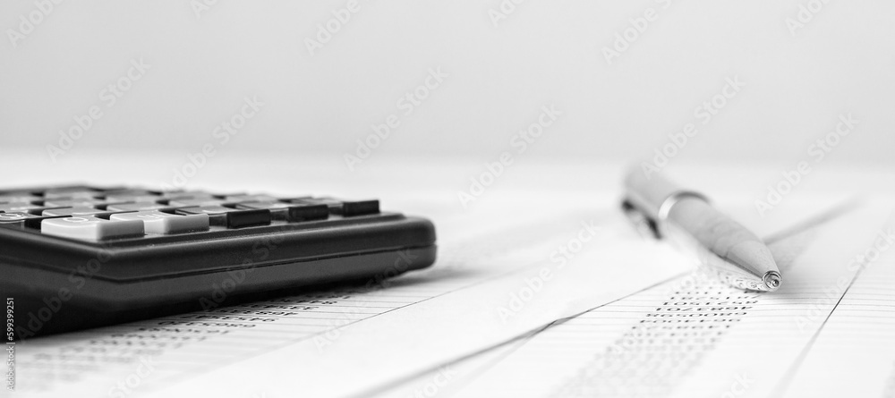 Poster calculator on financial statement and balance sheeet on desk of auditor. concept of accounting and a