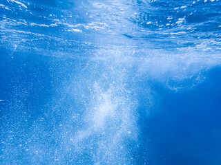 Fototapeta na wymiar Bubbles under the sea in the crystal clear green sea water. Mediterranean bubbles. Real image very suitable for backgrounds, Rising Bubbles in Deep Underwater, Under with bubble. Great for background.