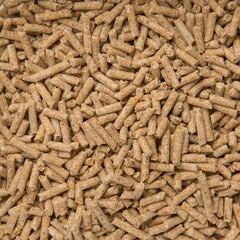 Close-Up Looped Rotation of Long Big Brown Wooden Sawdust Pellets - Natural Cat Litter Filler or Organic Fuel