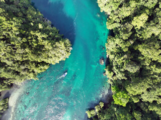 Boat traveling with the current in Wallace's Passage in Raja Ampat, West Papua, Indonesia