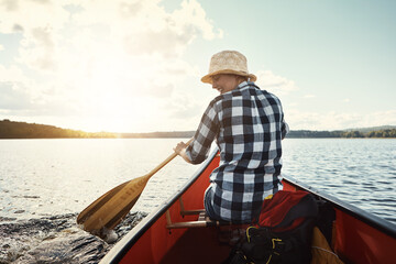 Lifes better on a kayak. an attractive young woman spending a day kayaking on the lake.