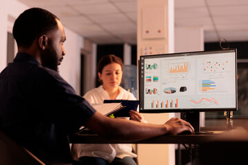 Financial analyst looking at company revenue report data on computer screen, corporate research...