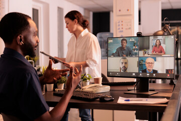 African american man speaking to remote team on videocall, attending online meeting, company...