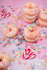 donuts with sprinkles on pink background