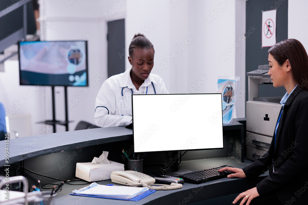 Poster receptionist using computer with white isolated screen at reception counter desk in hospital. facili
