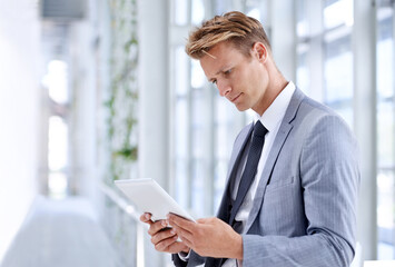 Fototapeta premium He has a drive for business. A young businessman standing in the workplace.