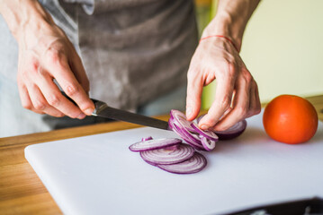 person slicing onion