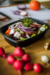 Boxed food, fresh vegetables and cheese