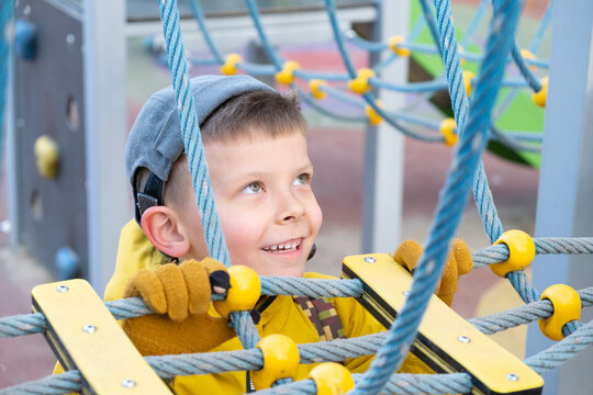 Six-year-old boy is playing on playground..