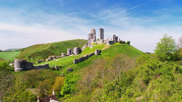 Aerial shot flying towards Corfe Castle  on summer day