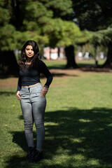 Portrait of teenage girl posing in a park. Model striking a pose in a park
