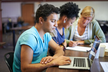 Working together to prepare for finals. A group of young people studying together for the upcoming exams.