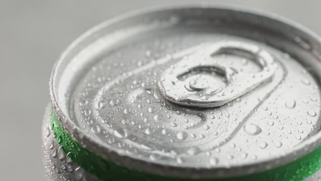 Opening soda or beer can, macro close up of can pull tab opening, watering refreshment, hand open lemonade or juice.