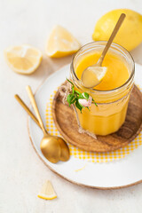 Homemade lemon curd on a light background