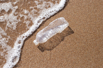 Fototapeta na wymiar Plastic bottle on the beach