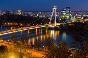 Fototapeta na wymiar Night view of illuminated Bratislava with futuristic Most SNP over Danube
