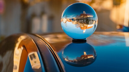 Crystal ball landscape shot with reflections on a car roof at Wiesenfelden, Bavarian forest,...