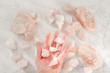 Rose quartz.Flying pieces of quartz in an open palm. precious gem stone. natural stone on rose...