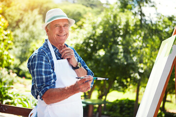 Im working on a masterpiece. Cropped portrait of a senior man painting in the park.