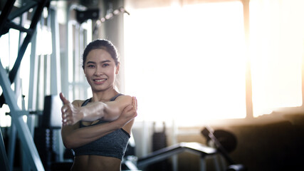 Asian woman in the gym, warming up in the gym, healthy exercise Concept.