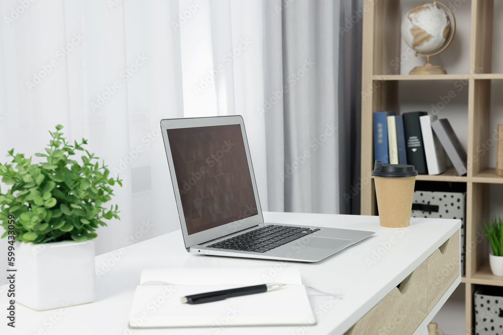 Poster Workplace with modern laptop on desk at home