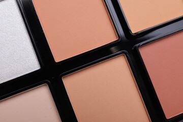 Colorful contouring palette as background, closeup. Professional cosmetic product