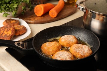 Cooking vegan cutlets in frying pan on stove