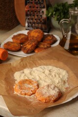 Raw vegan cutlets with flour on plate