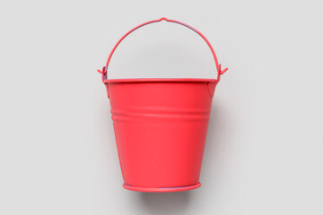 Red bucket on light background © Pixel-Shot