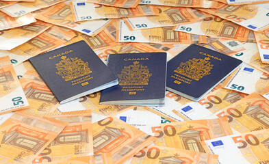 Canadian Passports on the fifty EURO bills background
